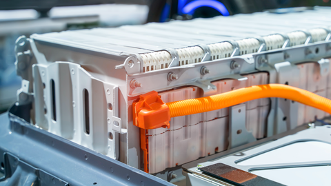 close-up of a large lithium-ion battery pack in an electric vehicle with an orange cable close-up of a large lithium-ion battery pack in an electric vehicle with an orange cable